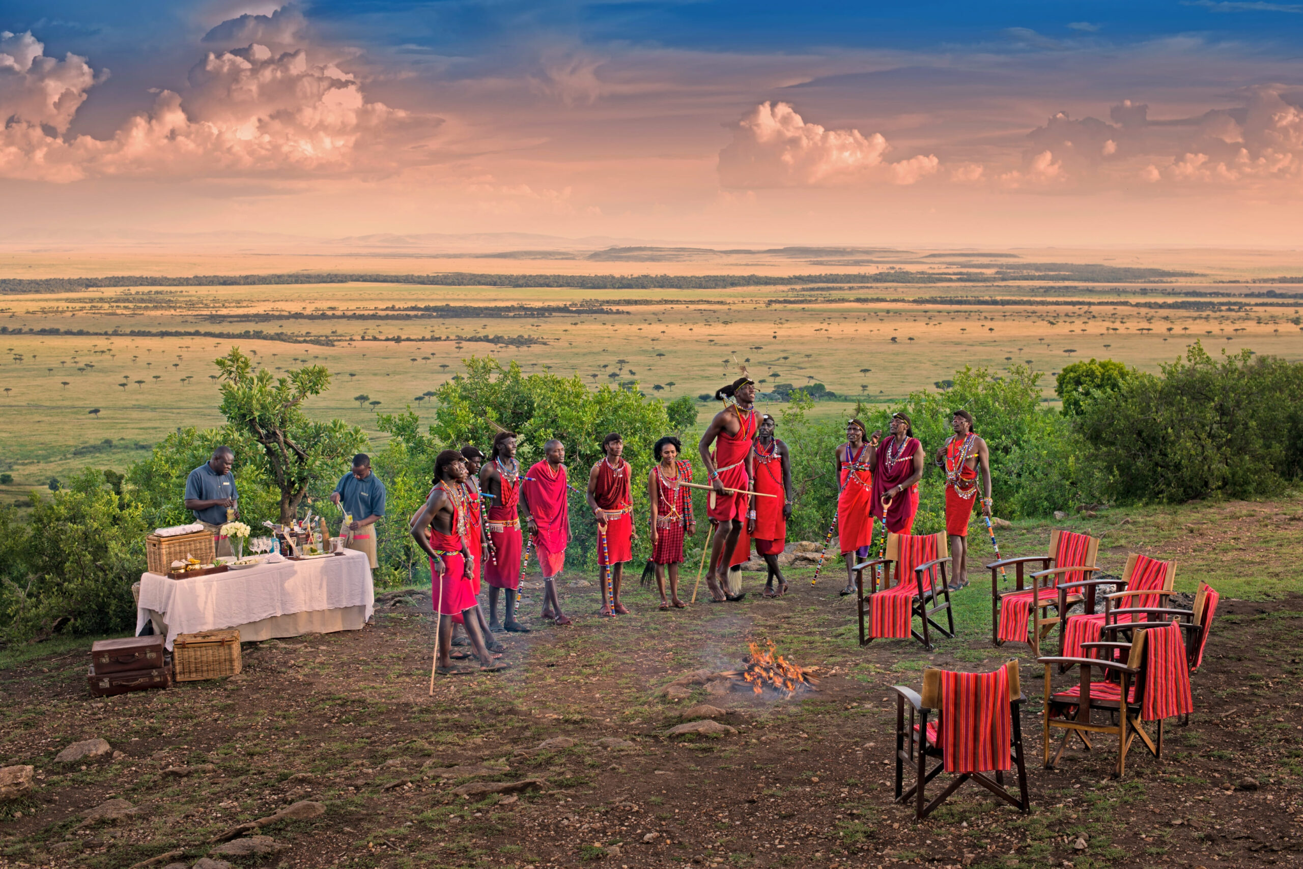 Maasai Dance at Sundowners — Maasai warriors performing the traditional adumu jumping dance at sunset.